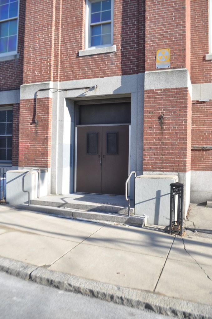 Up Academy/Patrick Gavin School-Exterior Fallout Shelter sign in rear of school